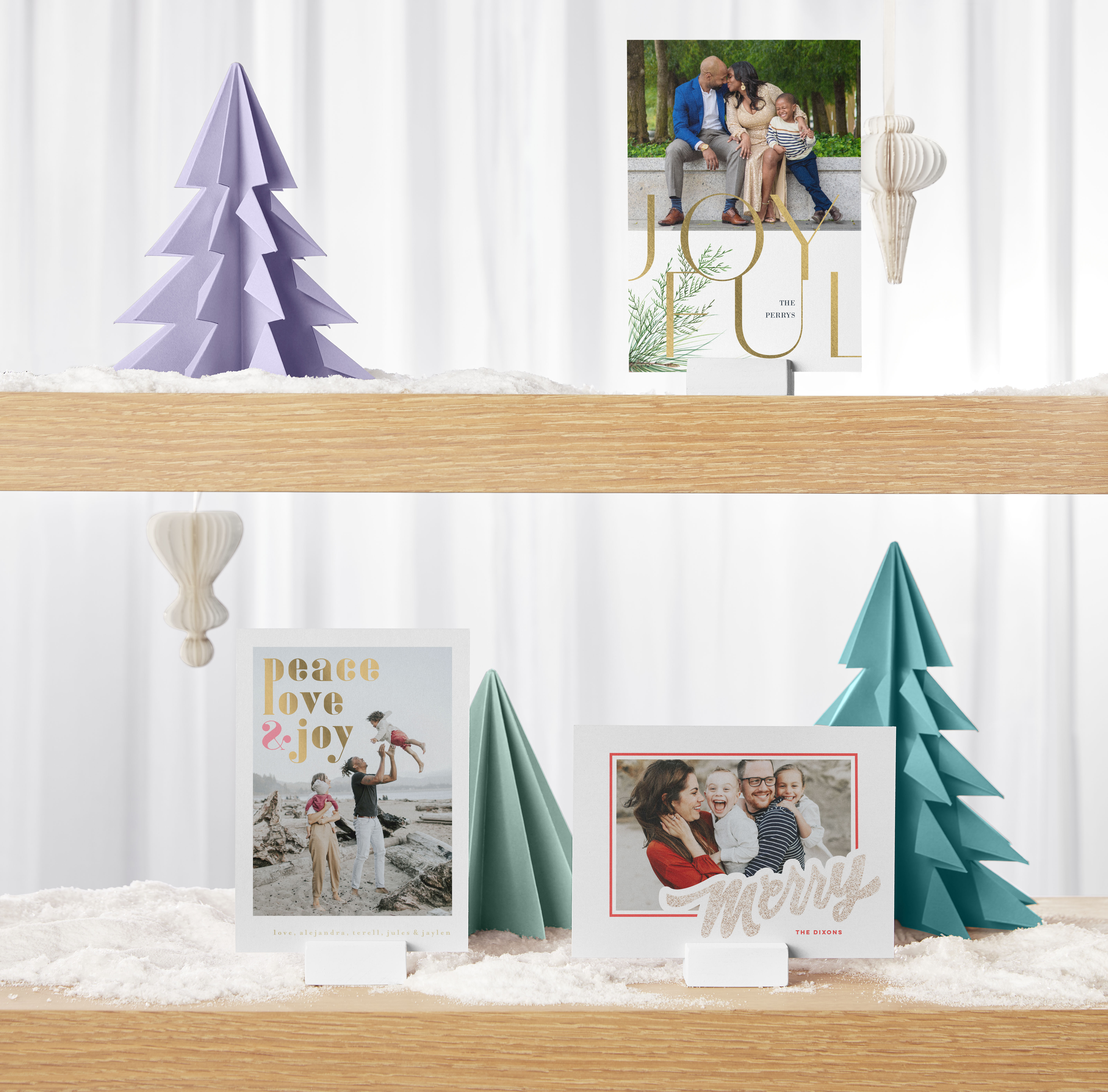 Christmas card display featuring purple and green paper Christmas trees